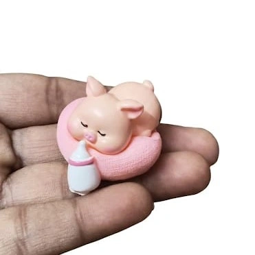 Adorable sleeping baby pig on a swim ring miniature figurine. A charming product for collectors.