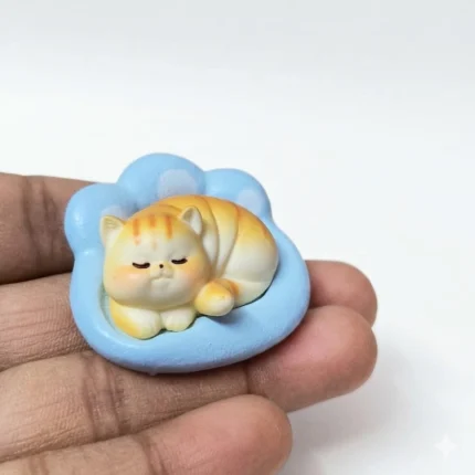 Sleeping orange tabby cat resin miniature figurine product on a paw base, perfect for tiny scenes.