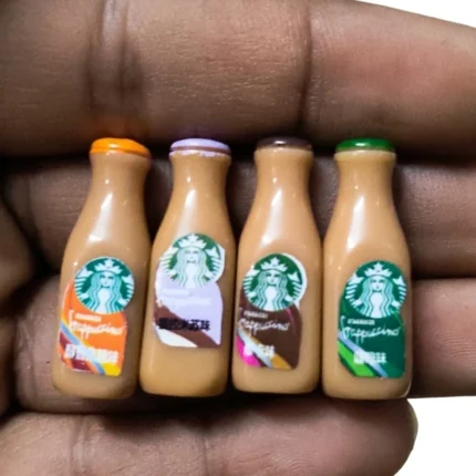 Highly detailed miniature Starbucks Frappuccino bottles, a collectible product for dollhouses or dioramas.