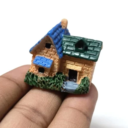 Detailed resin miniature house product: charming stone cottage with vibrant blue and green roof.