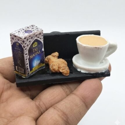 Miniature fridge magnet product: Taj Mahal tea tray with chai and croissant, ideal for collectors.