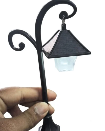 Victorian miniature street lamp post figurine with LED light. This product enhances dollhouse scenes.