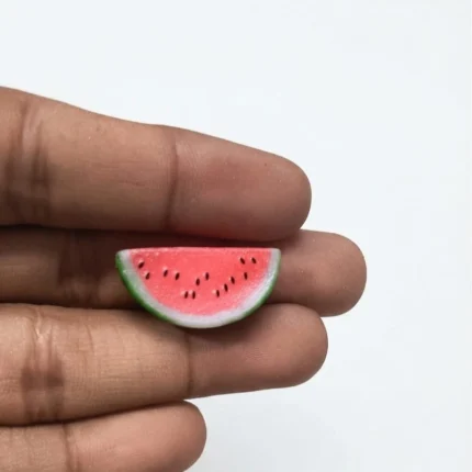 This realistic dollhouse watermelon slice figurine product adds a vibrant touch to any miniature food display.
