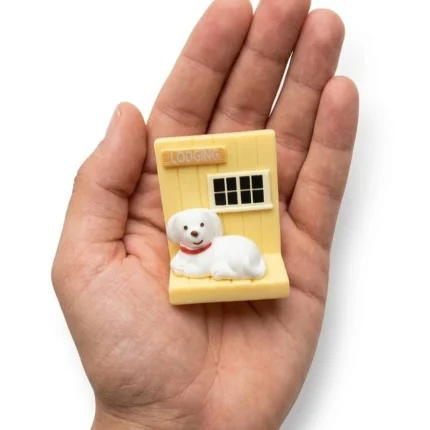 This product is a charming white dog flat-back miniature figurine, perfect for adding character to any scene.