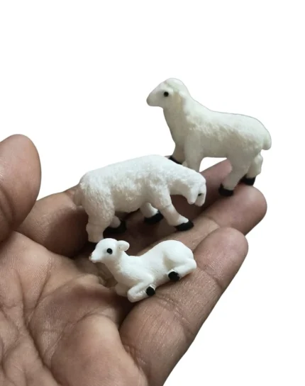 This product is a charming set of three white miniature sheep figurines, ideal for diorama or dollhouse scenes.