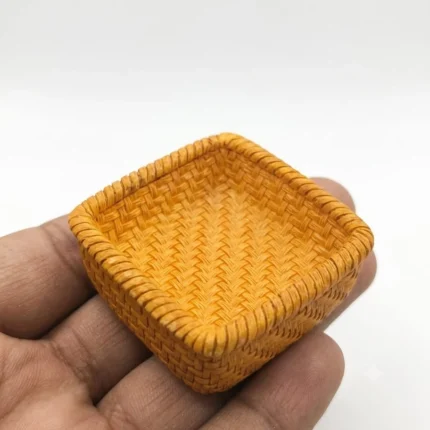 Detailed woven square dollhouse miniature basket product, perfect for rustic charm in any miniature scene.