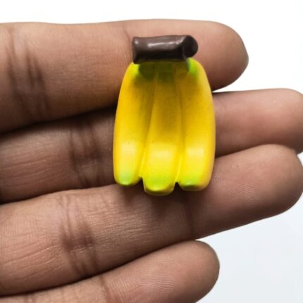Vibrant yellow miniature banana bunch figurine, realistic tiny food product for dollhouse or diorama.
