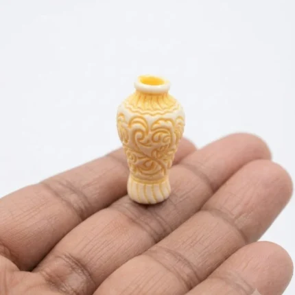 Cream miniature vase with intricate carved pattern, ideal for dollhouse product display.