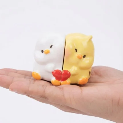 A delightful miniature chick couple product with a red heart, perfect for dollhouses or tiny scenes.