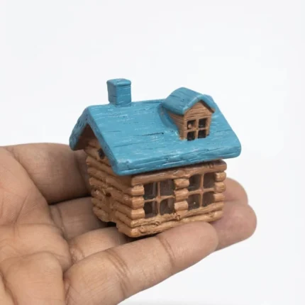 Detailed miniature log cabin house product with charming blue roof, ideal for dollhouse or fairy garden.