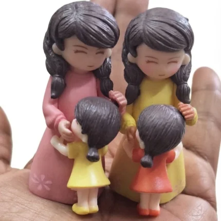 Charming miniature mother and daughter figurine set, a delightful decorative product for any collection.