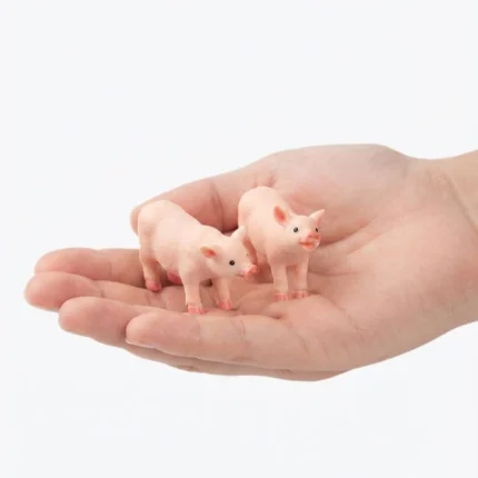 A charming miniature pink pig figurine, a random piece from the collection, displayed as a collectible product.