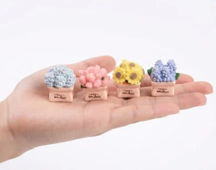 Product image showing four delightful miniature potted flowers, each in a tiny sack, ideal for dollhouse decor.