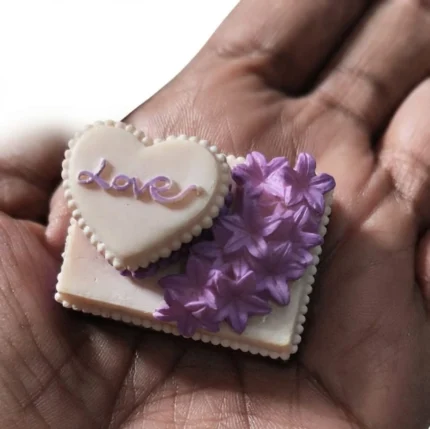 Beautifully crafted miniature square love cake product with delicate purple flowers for dollhouse display.