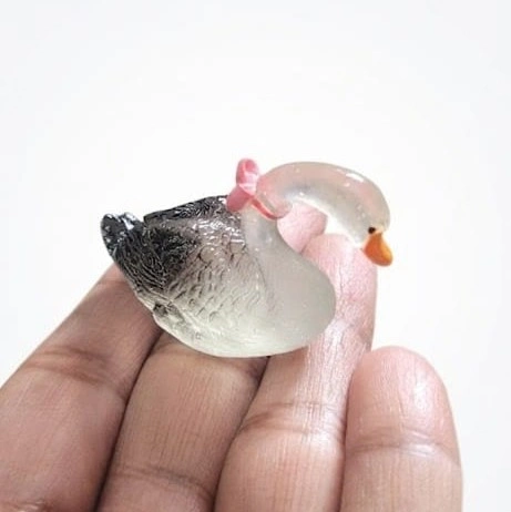 Miniature-Swan-Figurine-with-Pink-Bow-Detail Miniature swan figurine product: graceful white swan with delicate pink bow, perfect for miniature scenes.