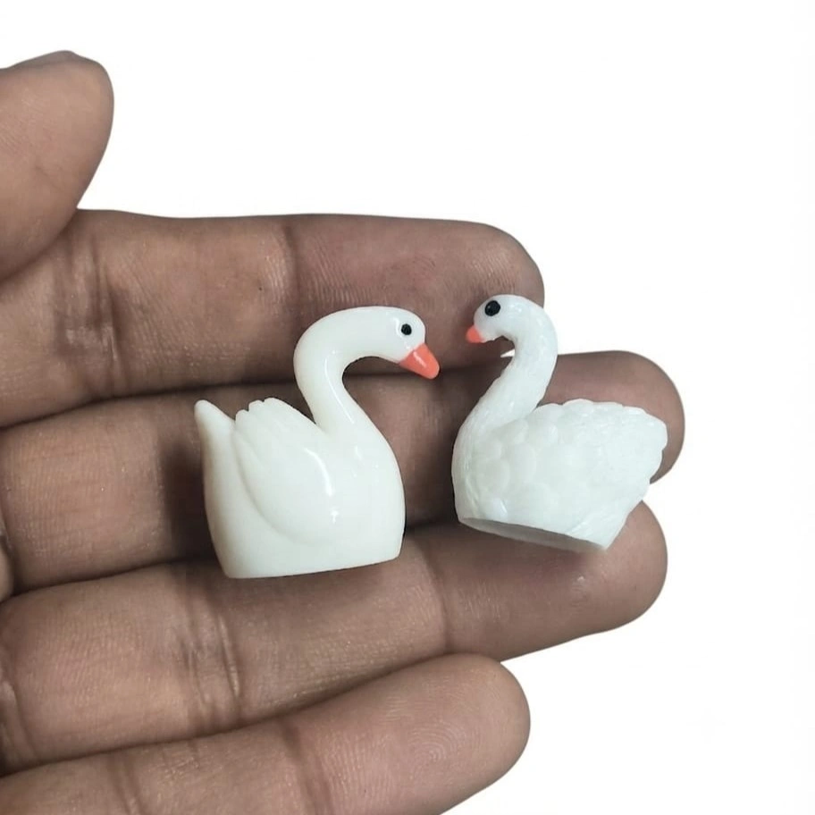 Miniature-White-Swan-Figurine-Set-of-2 A beautiful miniature white swan figurine set of two, perfect for enhancing any dollhouse or diorama product scene.
