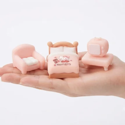 A charming pink miniature bedroom furniture set, a delightful product for dollhouse enthusiasts and collectors.