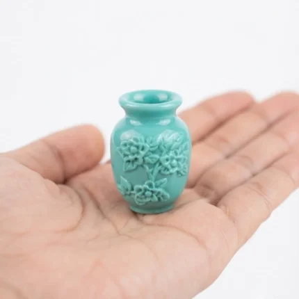 Teal miniature vase with carved flower details, a perfect product for dollhouse scenes.
