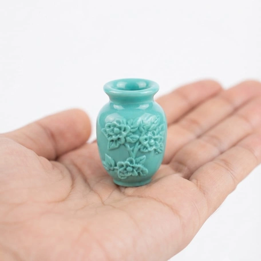 Teal-Miniature-Vase-with-Carved-Flowers Teal miniature vase with carved flower details, a perfect product for dollhouse scenes.