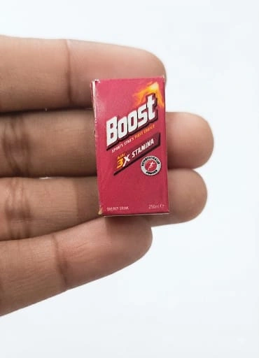 This product is a highly detailed miniature replica of a Boost energy drink carton, perfect for dollhouse scenes.