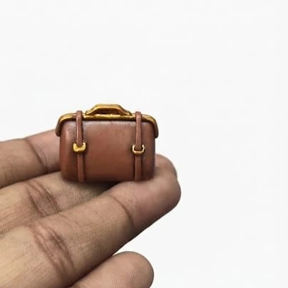 Detailed brown miniature travel suitcase figurine product, ideal for dollhouse scenes and dioramas.