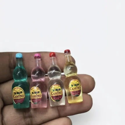 A charming product featuring a miniature bottle set of 4 assorted Camino bottles, perfect for dollhouse scenes.