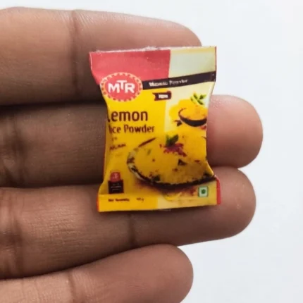 Detailed miniature MTR Lemon Rice Powder masala packet product for dollhouse or collectible display.