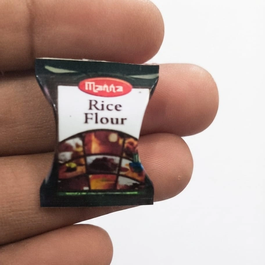 Manna-Rice-Flour-Miniature-Packet Realistic miniature Manna rice flour packet for dollhouse kitchens or diorama scenes, a tiny grocery product.