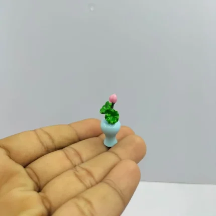 Handcrafted miniature blue vase product with delicate lotus leaf and bud, ideal for dollhouse displays.