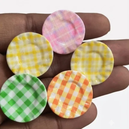 Charming miniature checkered round plate product with a random pattern, perfect for dollhouse or diorama displays.