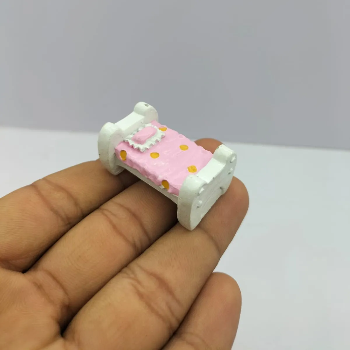 Miniature-Dollhouse-Bed-with-Pink-Polka-Dot-Bedding Miniature dollhouse bed with pink polka dot bedding. This product adds a cozy touch to any dollhouse bedroom.