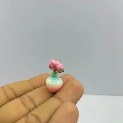 Beautifully crafted miniature flower vase with delicate pink roses, a decorative product for dollhouses.