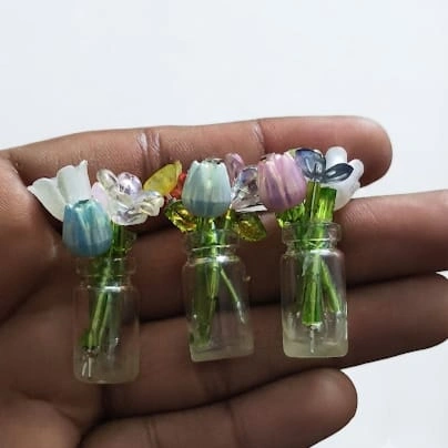 This miniature glass flower vase product is ideal for adding elegance to any dollhouse or diorama scene.