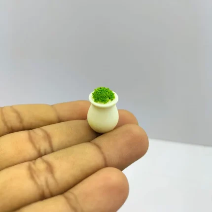 Detailed miniature green moss plant in a white vase, perfect for enhancing dollhouse or diorama product scenes.