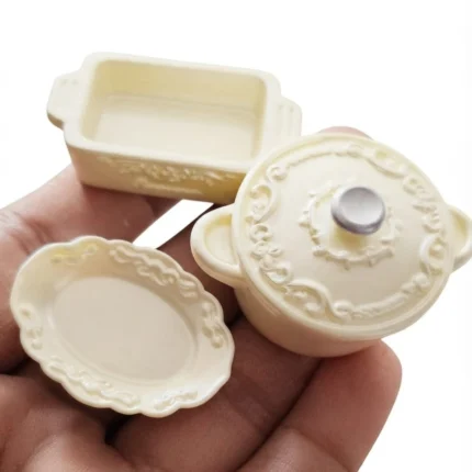 Detailed miniature ivory cookware and dinnerware set for dollhouse kitchen scenes, a high-quality product.