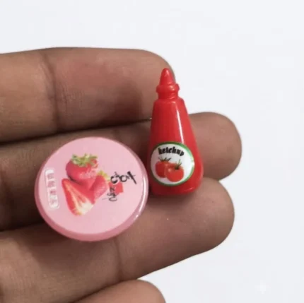Miniature food set product featuring a tiny ketchup bottle and a small strawberry jam jar for dollhouses.