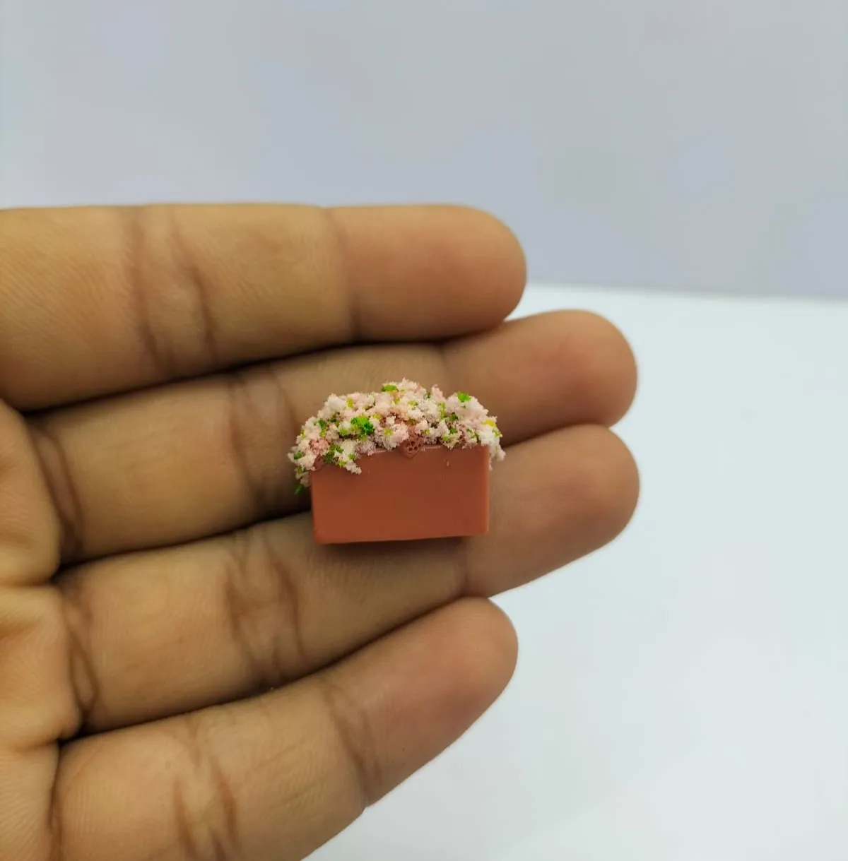 Miniature-Pink-Blossom-Plant-in-Square-Terracotta-Pot Detailed miniature pink blossom plant product in square terracotta pot, ideal for dollhouse scenes.