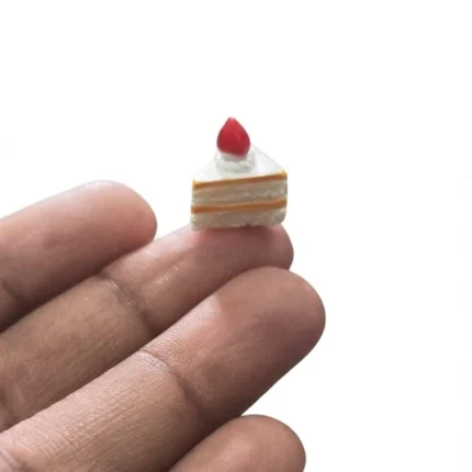 Highly detailed miniature strawberry cake slice figurine, a handcrafted product for dollhouse collectors.