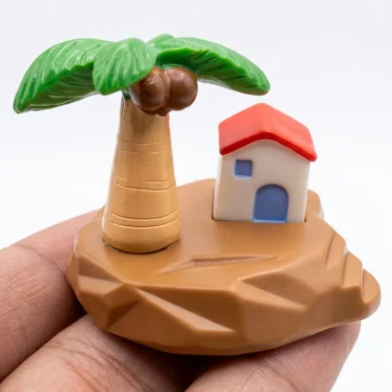 Miniature tropical island scene product with a detailed palm tree, charming tiny house, and sandy beach.