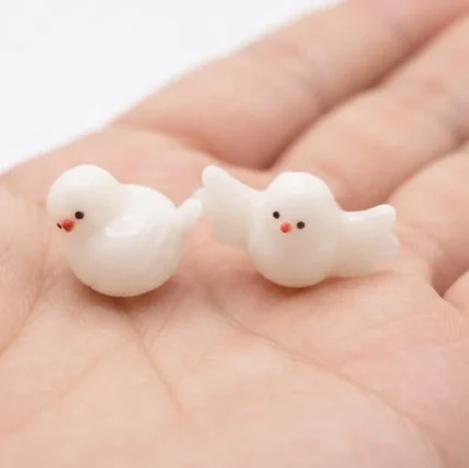 A charming miniature white bird figurine product, randomly selected, perfect for dollhouse scenes or tiny decor.