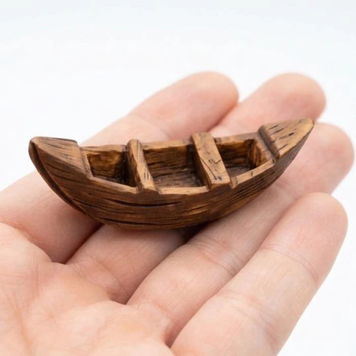 Miniature-Wooden-Rowboat-Figurine Beautifully detailed miniature wooden rowboat figurine product for dollhouse or nautical display.