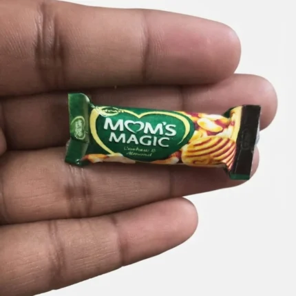 Detailed miniature product of Moms Magic Cashew Almond biscuit pack, ideal for dollhouse displays.