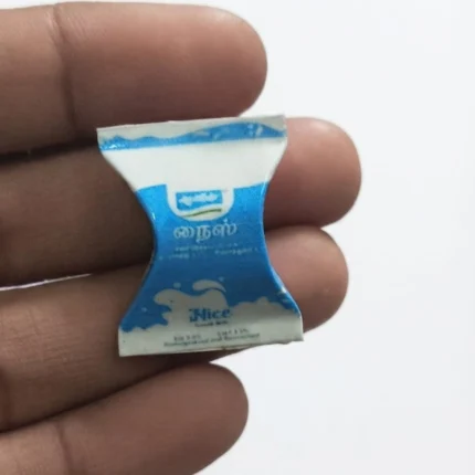 Miniature milk sachet, highly detailed for dollhouse grocery scenes, adding realism to your product display.