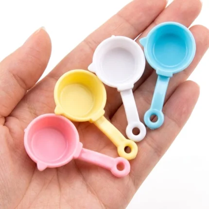 A charming pastel miniature saucepan product, randomly selected, perfect for enhancing any dollhouse kitchen scene.