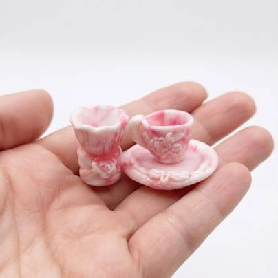 Pink floral dollhouse tea cup and saucer miniature set product, perfect for tiny scenes.