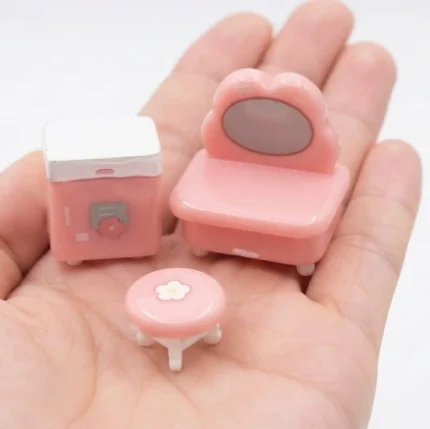 Beautifully crafted pink miniature dressing table and stool set, a charming product for dollhouse bedrooms.