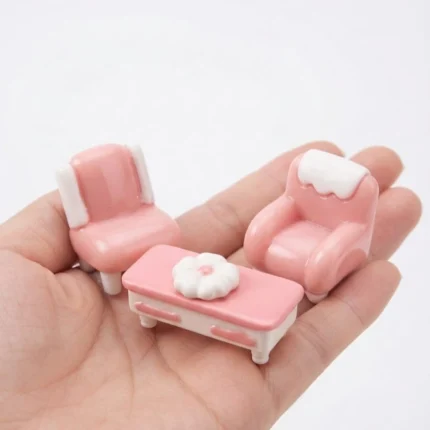 A delightful pink miniature living room furniture set, perfect for enhancing any dollhouse or diorama product.