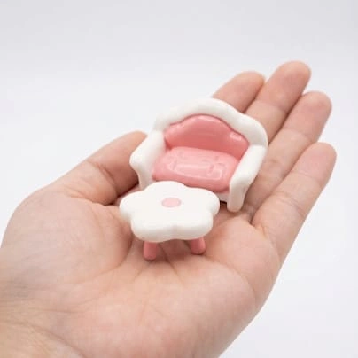 Pink miniature sofa and coffee table set product, ideal for dollhouse living rooms, adding a cozy touch.