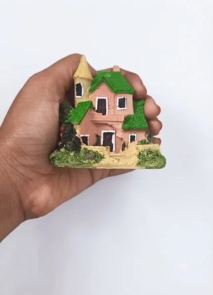 This charming pink two-storey cottage miniature house with a detailed garden is a delightful product.