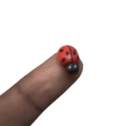 Red ladybug miniature figurine product, perfect for adding color to any miniature display or dollhouse scene.